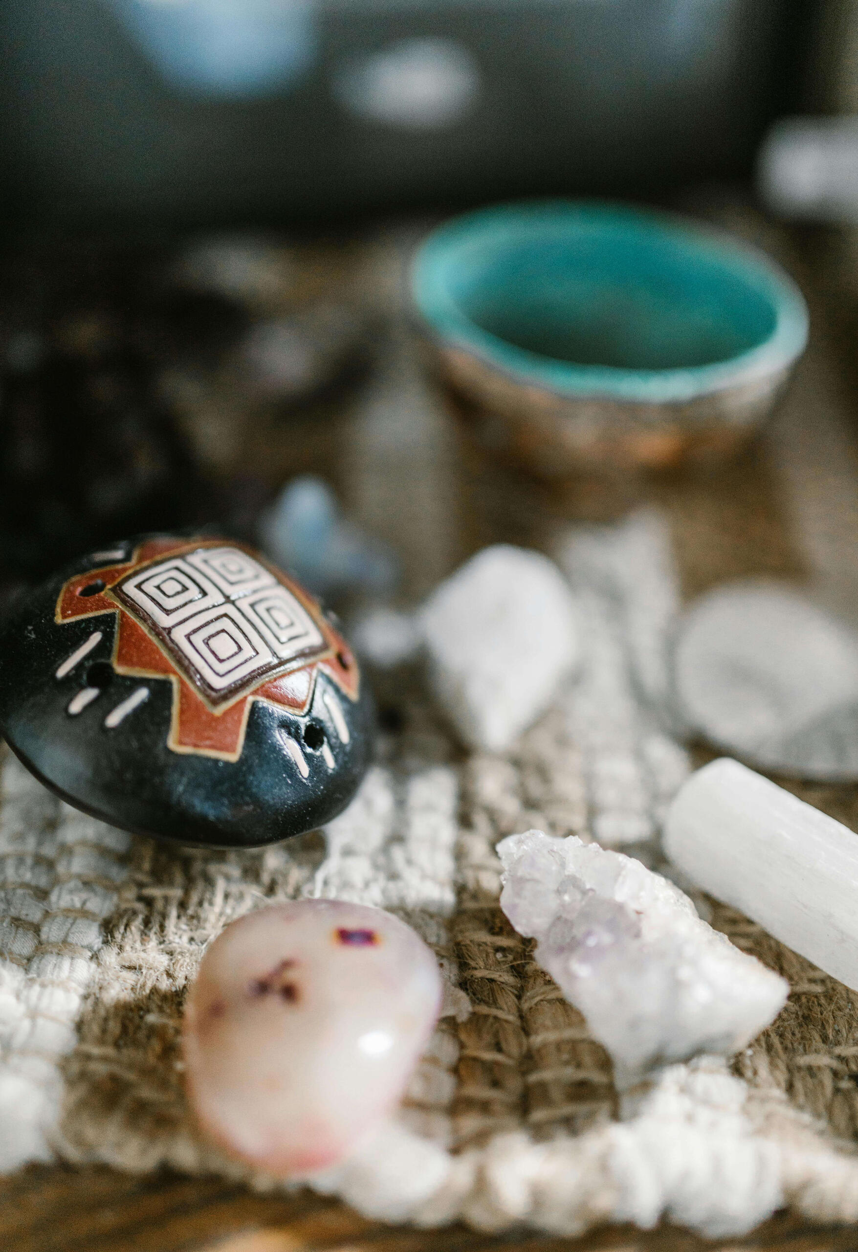 Manifest with crystals Photo of some white crystals along with a painted rock and bowl.
